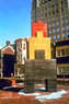 Major, view 2, ©1982<br>Commission for Berger Associates for Postal Workers' House. The work, sited on a plaza in front of the building, refers to both stacked, toy-like figures, and to the three storied row houses common to Philadelphia. The largest of the three forms straddles a space to form a kind of triumphal arch only high enough for children to pass through. <br>
Pigmented concrete, 23'h x 10'w x 3'd <br>
Eight and Locust Streets, Philadelphia, Pennsylvania