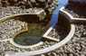Tidal Park, detail, ©1988<br>In collaboration with artist Douglas Hollis. A commission for a public waterfront park. <br>
View of tide clock at low tide. The spiral form fills and empties during a 12' tidal cycle creating a man-made tide pool and marine observatory. <br> 
Concrete, stone and water. <br>
Site: 150' x 350'. Port Townsend, Washington